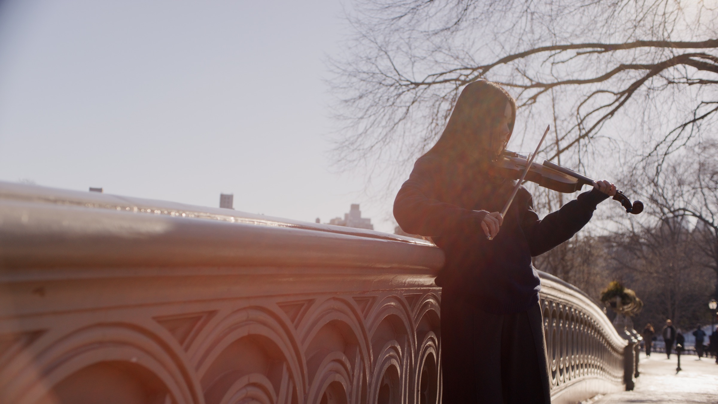 Concerto film still with violinist in winter sunlight