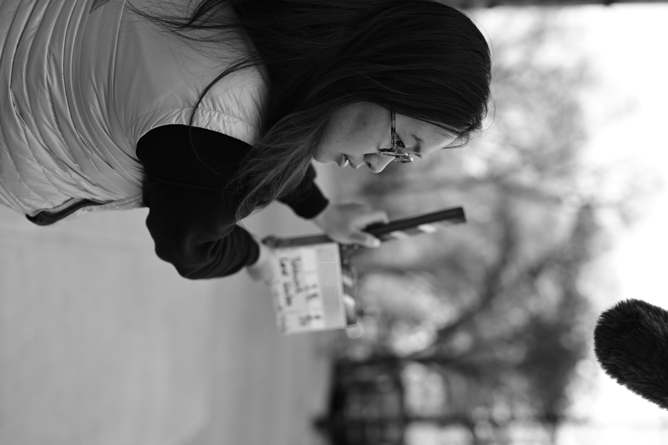 Black and white image of Zhu ShengTing on a production call