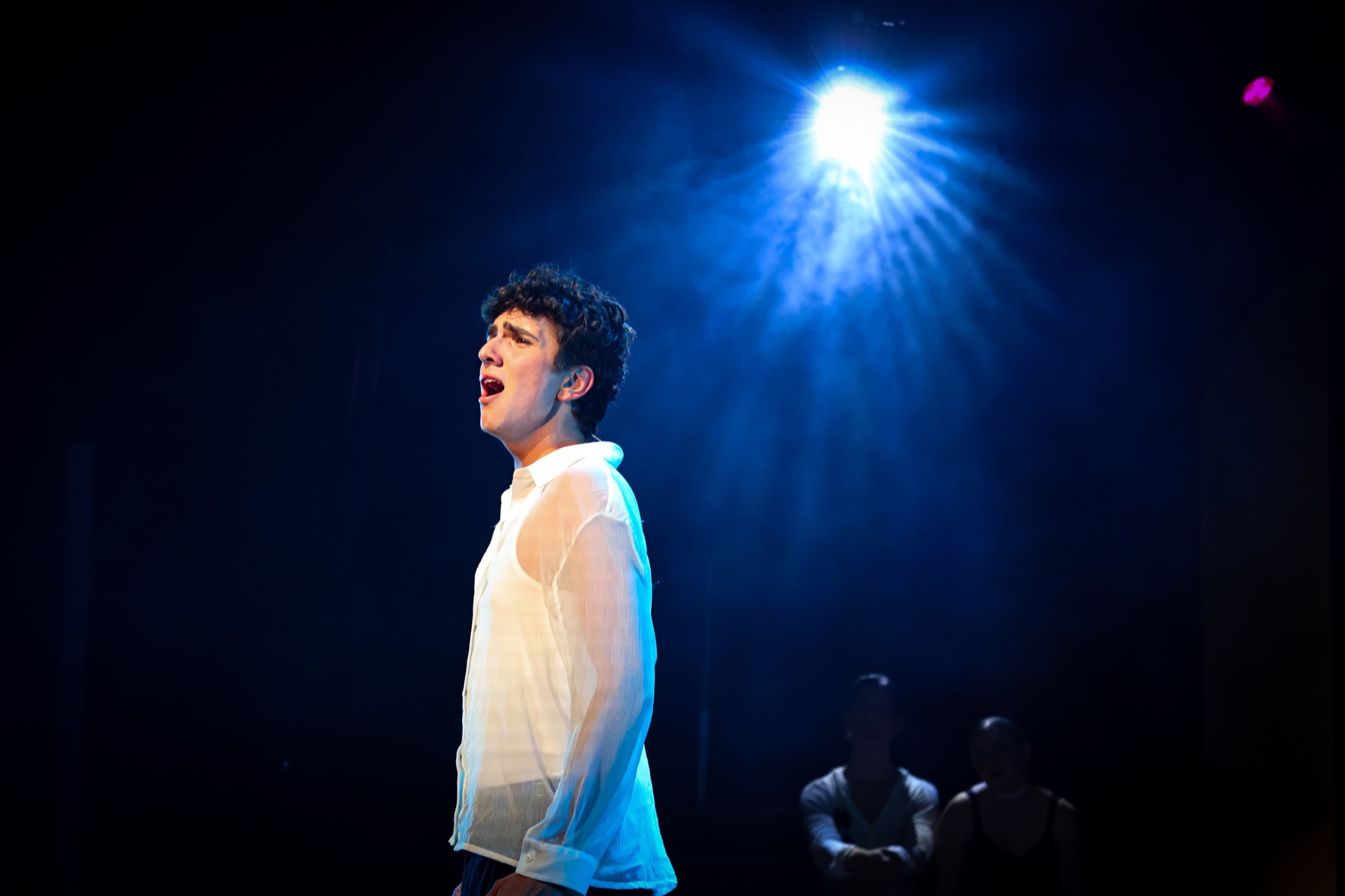 Pippin performer under blue stage light